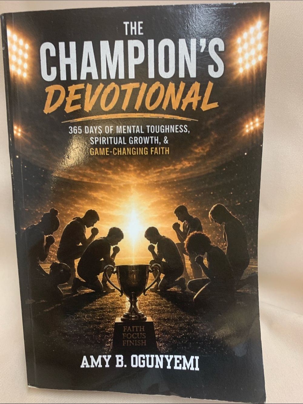 The Champion's Devotional by Amy B. Ogunyemi - Black & Gold Cover